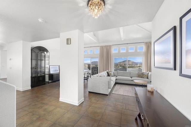 6356 Camino Largo, San Diego, CA 92120 - living room featuring baseboards, a chandelier, dark tile patterned flooring, and arched walkways