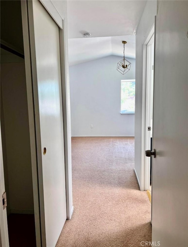 8109 Birch St, Bakersfield, CA 93311 - hallway with light colored carpet, vaulted ceiling, and baseboards
