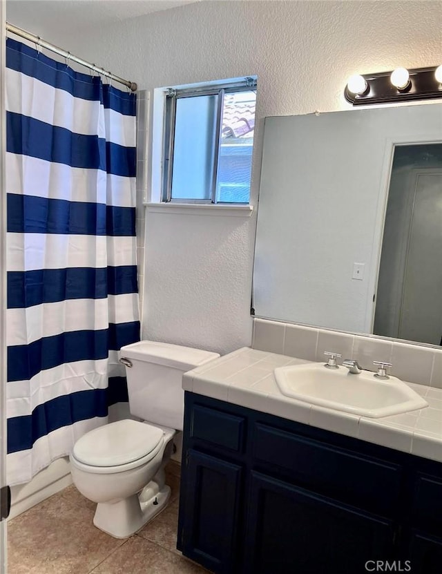 8109 Birch St, Bakersfield, CA 93311 - bathroom featuring tile patterned floors, toilet, curtained shower, a textured wall, and vanity