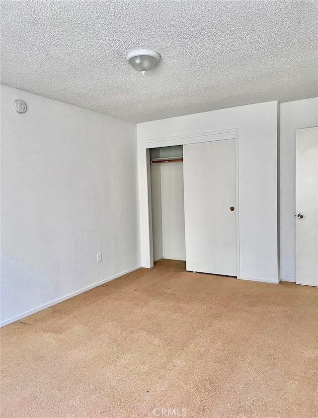 8109 Birch St, Bakersfield, CA 93311 - unfurnished bedroom featuring a textured ceiling, a closet, and light colored carpet