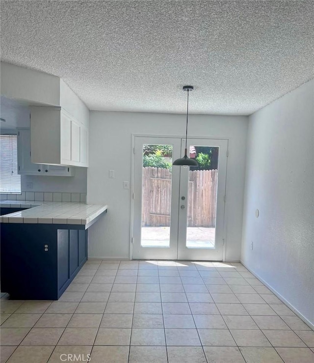 8109 Birch St, Bakersfield, CA 93311 - kitchen featuring french doors, a textured ceiling, tile countertops, and light tile patterned floors