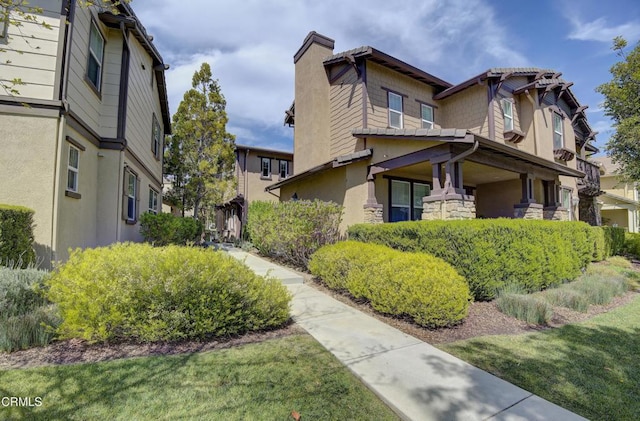 view of home's exterior featuring a chimney and stucco siding