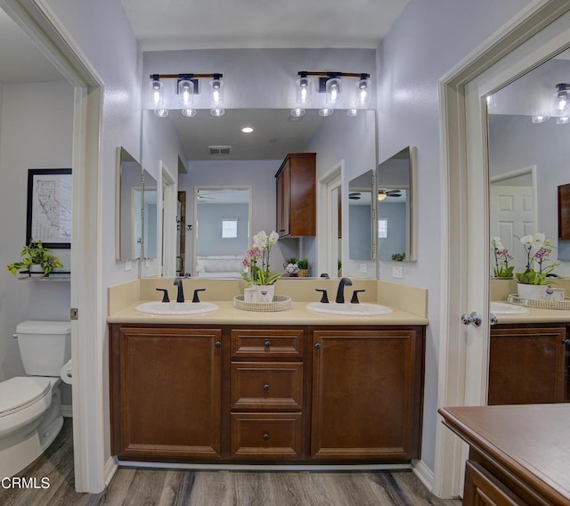 full bathroom with wood finished floors, visible vents, and a sink