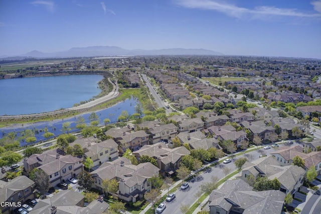 drone / aerial view featuring a residential view and a water and mountain view
