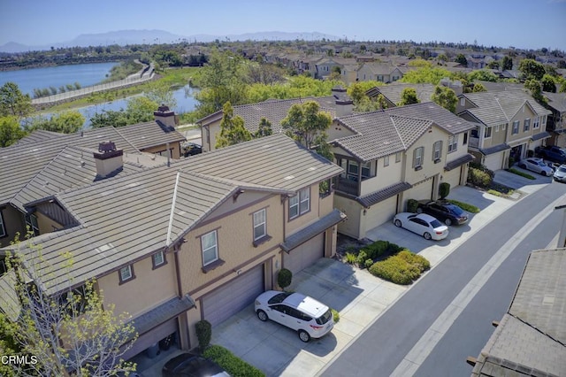 bird's eye view with a water view and a residential view