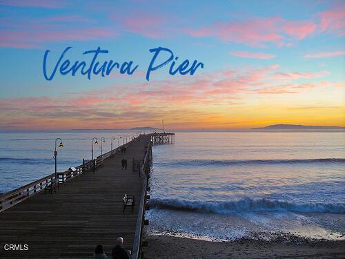 dock area with a beach view, a pier, and a water view