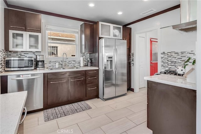 kitchen with tasteful backsplash, visible vents, a sink, dark brown cabinetry, and stainless steel appliances