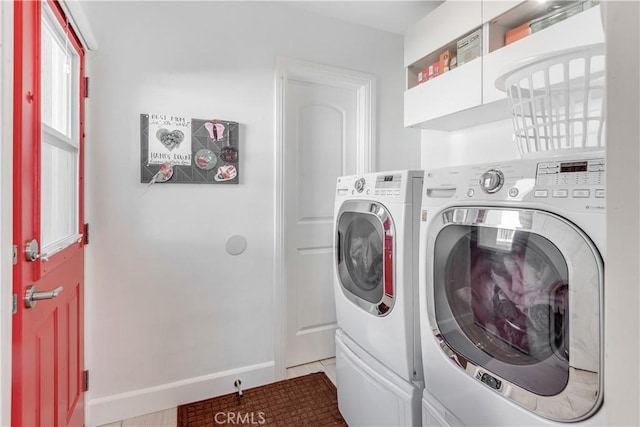 laundry room featuring baseboards, independent washer and dryer, and laundry area