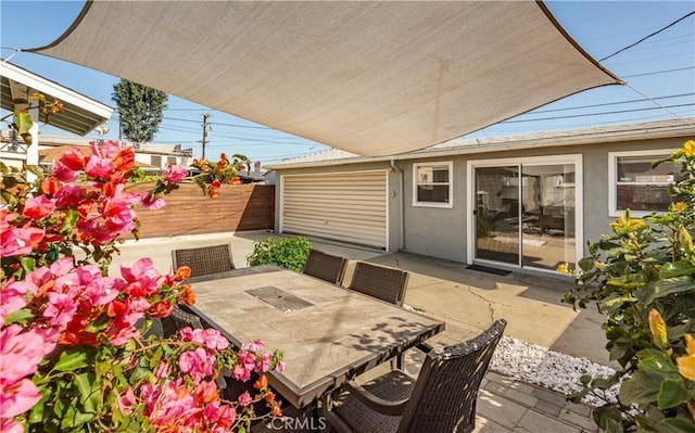 view of patio / terrace featuring outdoor dining area and fence