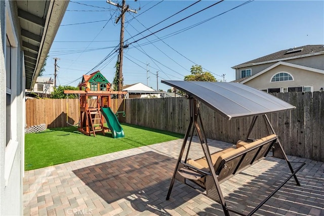 view of patio / terrace featuring a fenced backyard and a playground