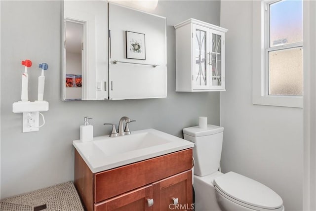 bathroom featuring toilet and vanity