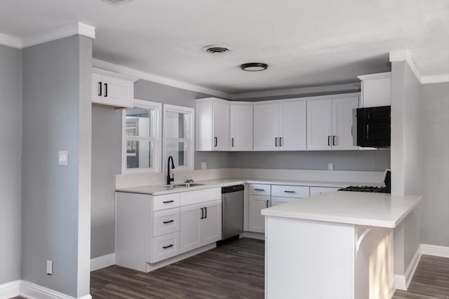 kitchen with a peninsula, dark wood-type flooring, visible vents, stainless steel dishwasher, and a sink