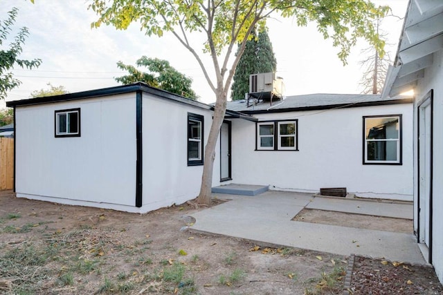 back of house with a patio area and central AC