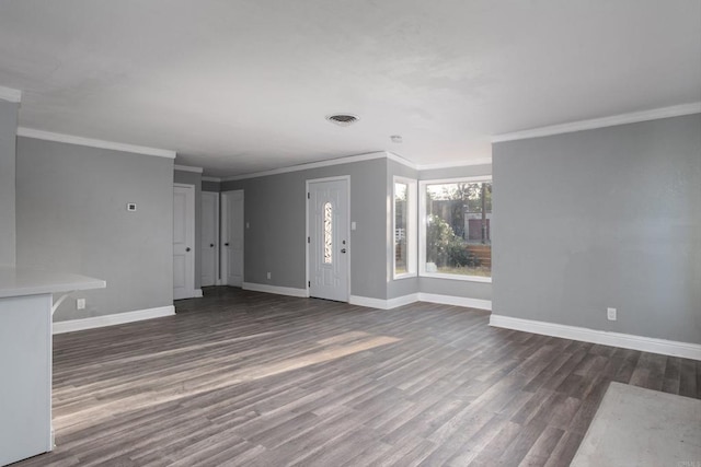 unfurnished living room featuring ornamental molding, visible vents, baseboards, and wood finished floors
