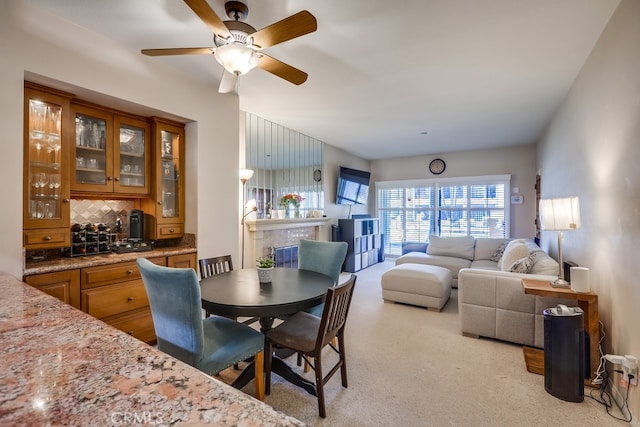 dining area featuring carpet and ceiling fan