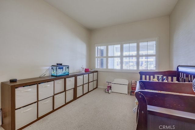 bedroom featuring carpet and baseboards