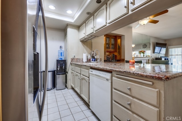 kitchen with a sink, white dishwasher, light tile patterned flooring, a peninsula, and ceiling fan