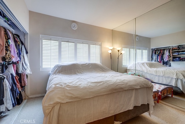 carpeted bedroom with multiple windows
