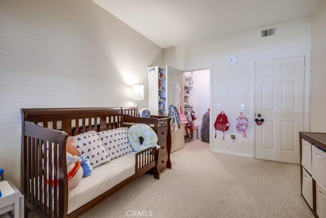 bedroom featuring visible vents and light colored carpet