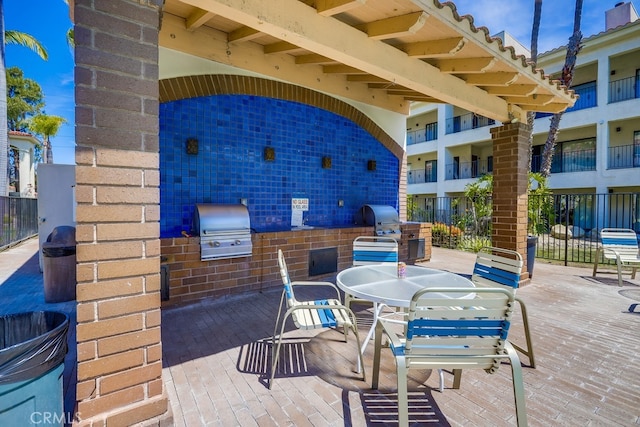 view of patio featuring an outdoor kitchen, grilling area, and outdoor dining area
