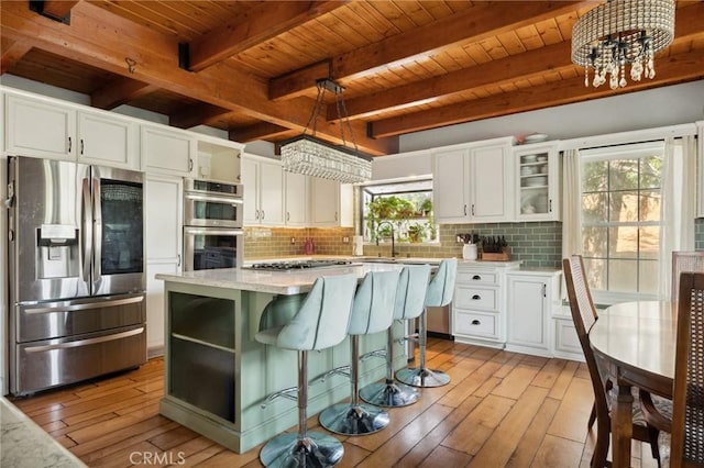 24540 Horst Dr, Crestline, CA 92325 - kitchen with wood ceiling, decorative backsplash, stainless steel appliances, and light wood-type flooring