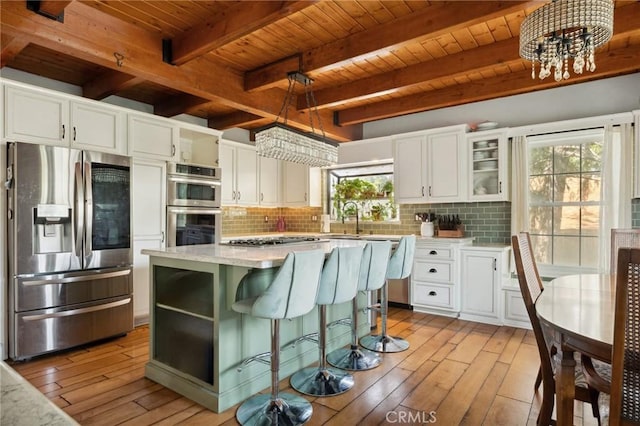24540 Horst Dr, Crestline, CA 92325 - kitchen featuring stainless steel appliances, a wooden ceiling with exposed beams, light wood finished floors, and backsplash