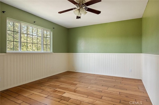 24540 Horst Dr, Crestline, CA 92325 - unfurnished room featuring a ceiling fan, wainscoting, and hardwood / wood-style floors
