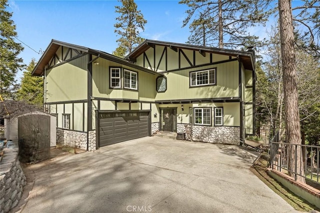 24540 Horst Dr, Crestline, CA 92325 - tudor-style house with a garage, a shed, driveway, and stone siding