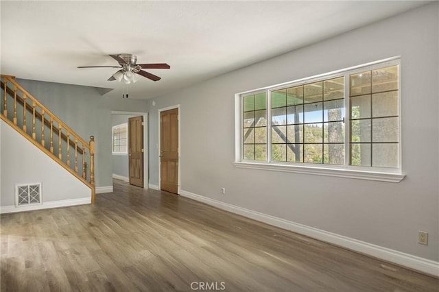 24540 Horst Dr, Crestline, CA 92325 - unfurnished living room with stairs, baseboards, visible vents, and ceiling fan