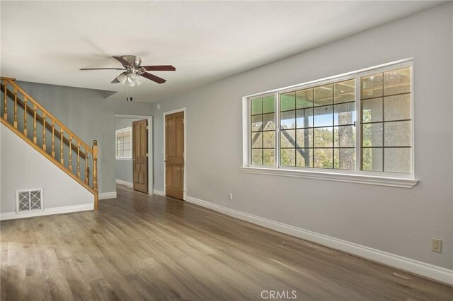 24540 Horst Dr, Crestline, CA 92325 - unfurnished living room featuring a ceiling fan, stairs, and wood finished floors