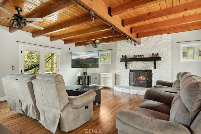 24540 Horst Dr, Crestline, CA 92325 - living area featuring a ceiling fan, a wooden ceiling with exposed beams, hardwood / wood-style flooring, a fireplace, and track lighting