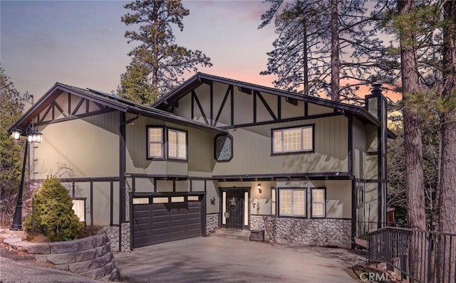 24540 Horst Dr, Crestline, CA 92325 - view of front of home featuring a garage, fence, stone siding, a chimney, and concrete driveway