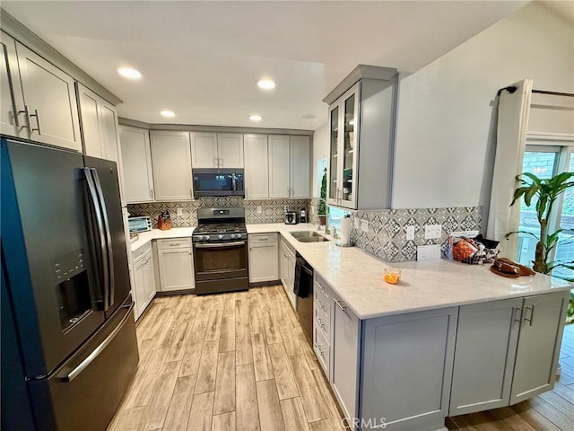 28236 Branch Rd, Castaic, CA 91384 - kitchen featuring gray cabinetry, light wood-style floors, black appliances, and a peninsula