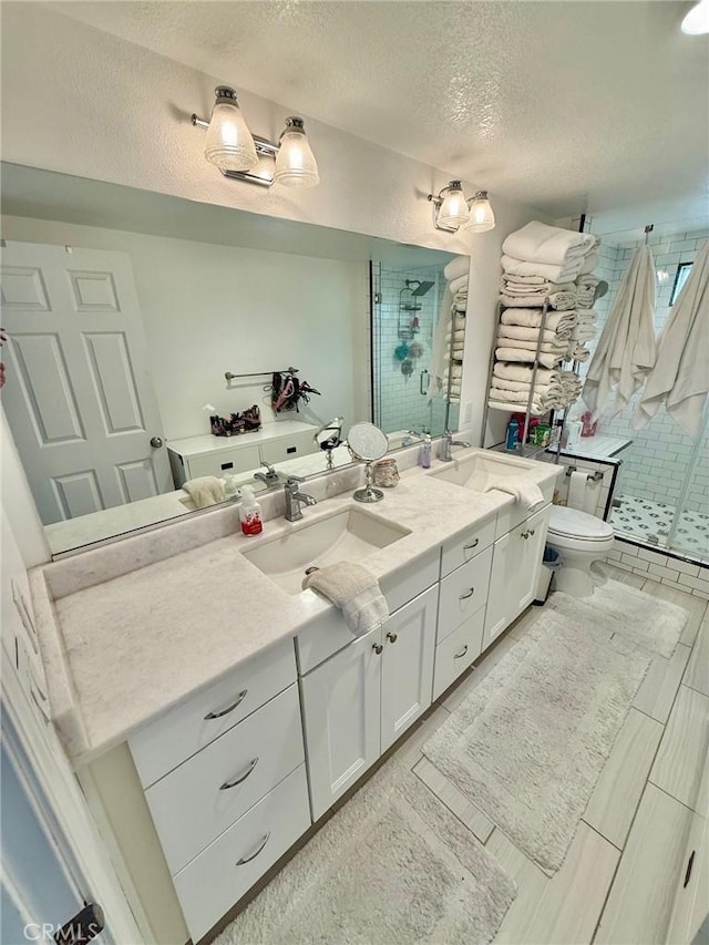 28236 Branch Rd, Castaic, CA 91384 - full bathroom featuring vanity, a shower stall, toilet, and a textured ceiling