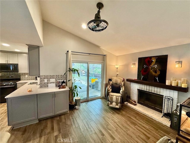 28236 Branch Rd, Castaic, CA 91384 - living area with high vaulted ceiling, a brick fireplace, recessed lighting, and wood finished floors