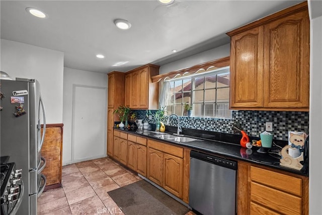 1435 W 50th St, Los Angeles, CA 90062 - kitchen with stainless steel appliances, a sink, dark countertops, decorative backsplash, and brown cabinetry