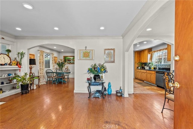 1435 W 50th St, Los Angeles, CA 90062 - foyer featuring crown molding, arched walkways, light wood-style floors, recessed lighting, and baseboards