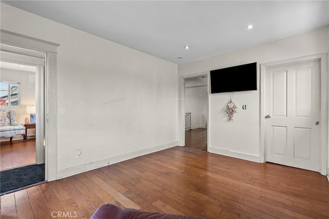 1435 W 50th St, Los Angeles, CA 90062 - unfurnished living room featuring wood-type flooring, baseboards, and recessed lighting