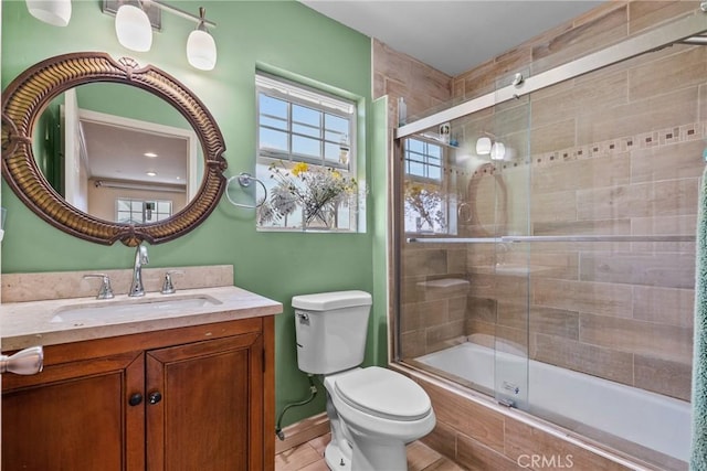 1435 W 50th St, Los Angeles, CA 90062 - full bathroom with tiled shower / bath combo, toilet, vanity, tile patterned flooring, and baseboards