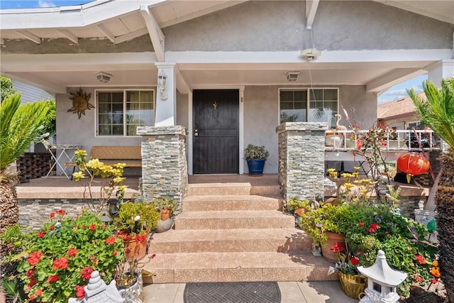 1435 W 50th St, Los Angeles, CA 90062 - entrance to property featuring covered porch, stucco siding, and stone siding