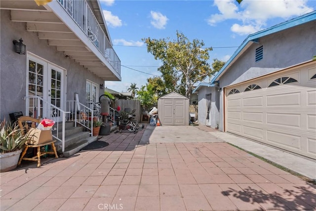 1435 W 50th St, Los Angeles, CA 90062 - view of patio / terrace with a garage, driveway, and a balcony