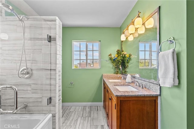 1435 W 50th St, Los Angeles, CA 90062 - full bath featuring double vanity, plenty of natural light, a stall shower, and baseboards