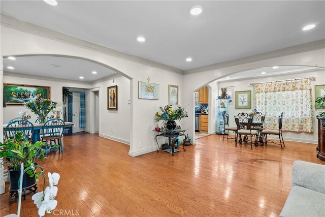 1435 W 50th St, Los Angeles, CA 90062 - living room with arched walkways, ornamental molding, light wood-style flooring, baseboards, and recessed lighting
