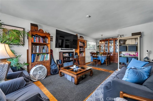 living room featuring wood finished floors and a notable chandelier