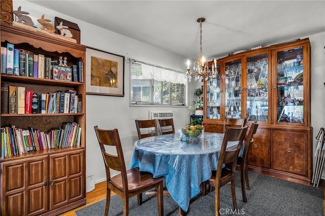 dining area with an inviting chandelier and wood finished floors