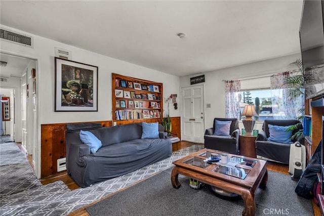 living room featuring visible vents and wood finished floors