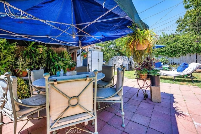 view of patio / terrace with outdoor dining space and fence