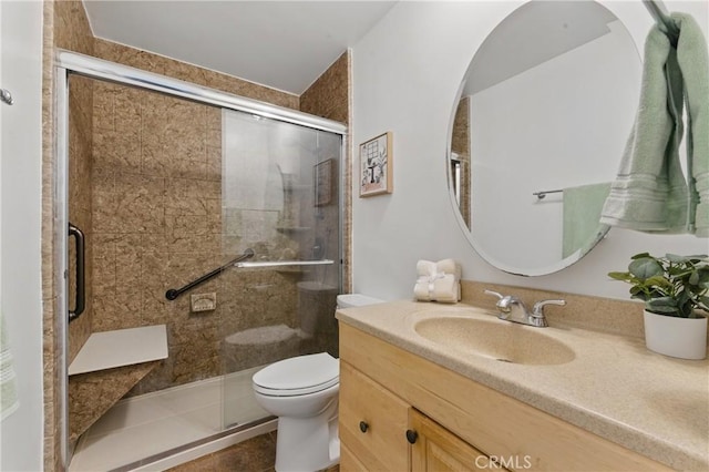 full bath with toilet, a stall shower, and vanity