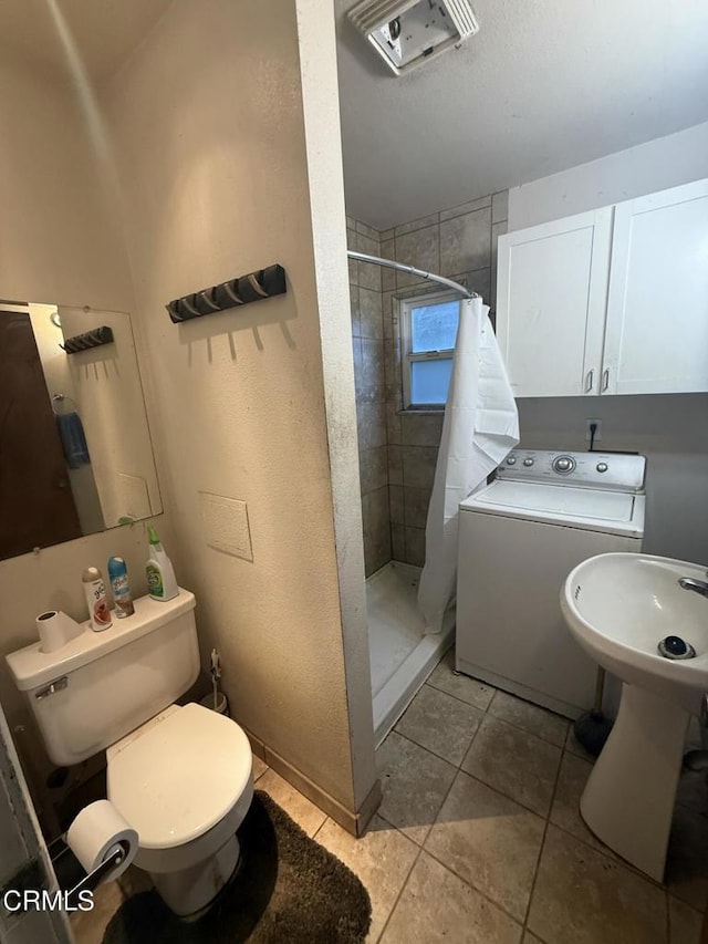 full bathroom with washer / clothes dryer, a sink, toilet, a shower stall, and tile patterned floors