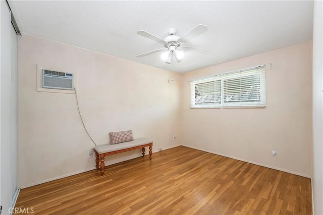 16230 Denley St, Hacienda Heights, CA 91745 - empty room with light wood-style floors, an AC wall unit, a ceiling fan, and baseboards